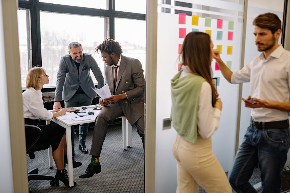 A vibrant office space where employees engage in conversations on their phones, showcasing a bustling and professional environment.