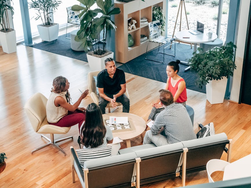 An image depicting a diverse team of professionals engaging with an auto answer machine in a modern office, showcasing its versatility in various business environments.