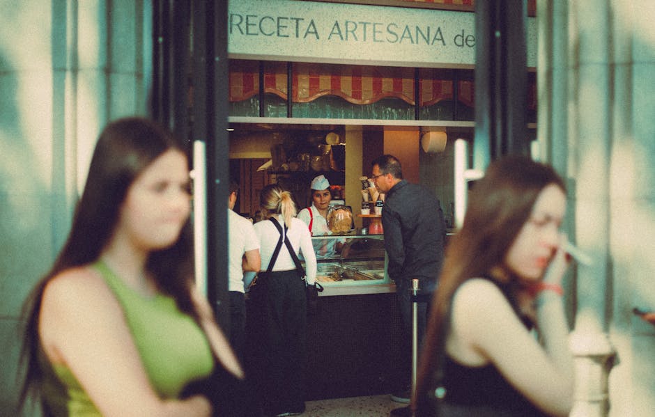 A bustling bakery storefront with customers enjoying their purchases, showcasing a vibrant business environment.