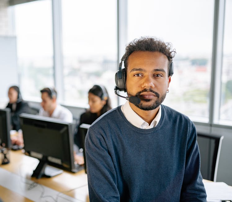 Image of a professional office environment where a customer service representative is engaging with a call recording system, showcasing modern technology and a compliant workspace.