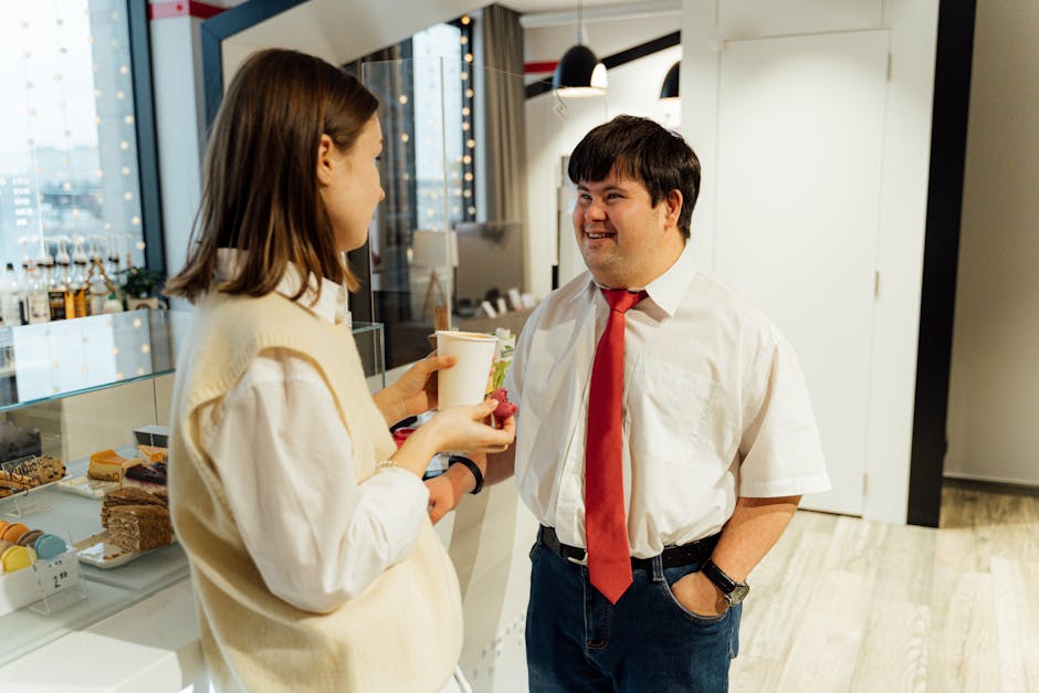 An image of a modern office with employees engaged in customer service calls, displaying data analytics on screens in the background.