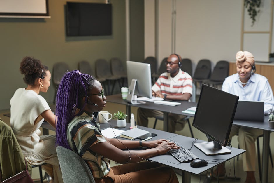 A modern office setting showcasing diverse professionals engaging in calls with business phones and wireless headsets.