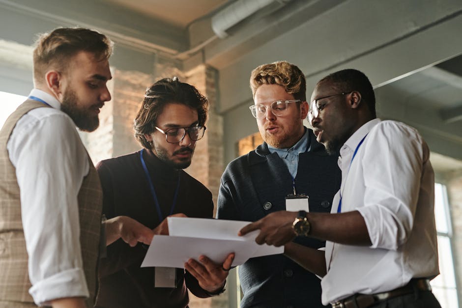 A team meeting with a diverse group analyzing voicemail transcriptions on screens.