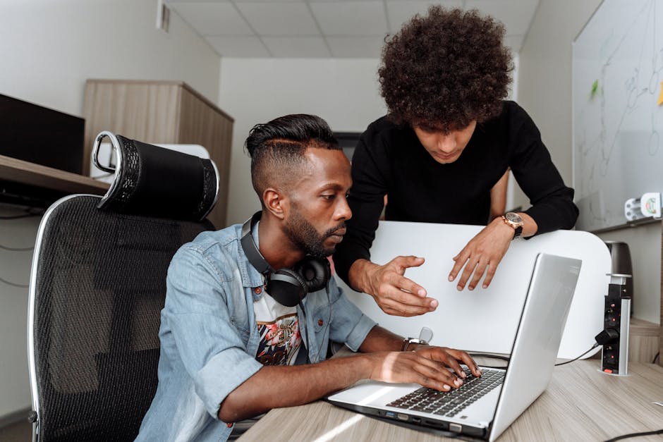 A sophisticated office environment with employees engaging in thoughtful collaboration using advanced technology