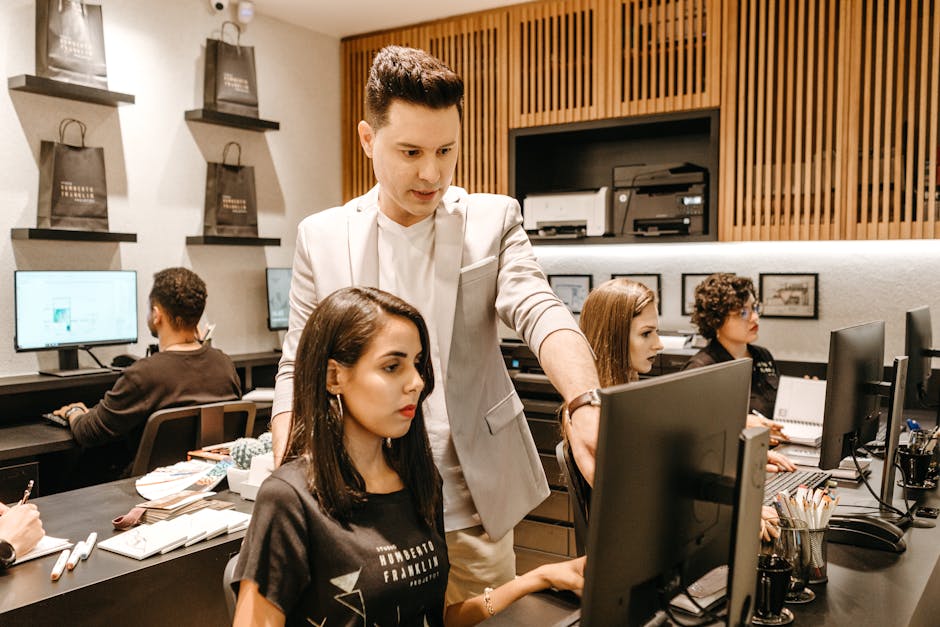 A busy office environment with employees enthusiastically managing customer calls and emails, showcasing technology in action.