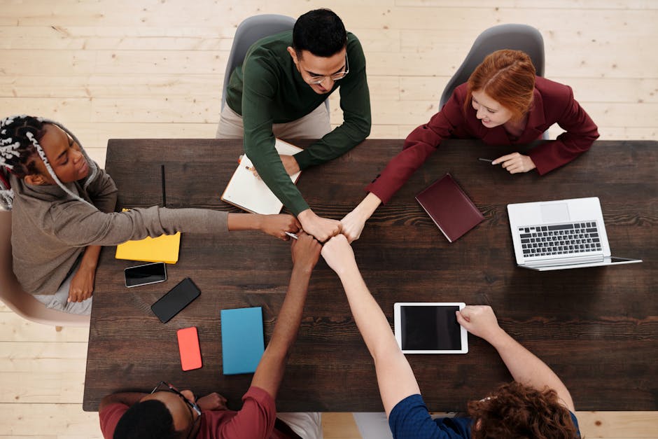 A vibrant office environment with a team collaborating over email and phone, symbolizing effective communication