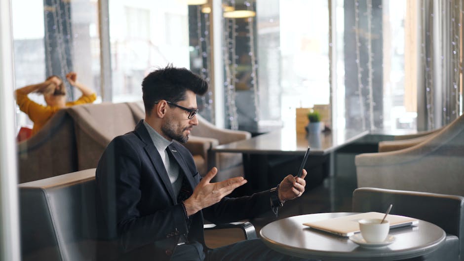 A dynamic workspace showing professionals using laptops and interacting through video calls, representing seamless business communication.