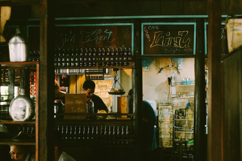 A small, bustling café with an AI receptionist helping customers at a counter, showcasing the synergy of technology and a cozy atmosphere.
