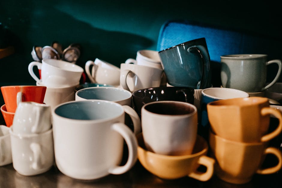 A beautifully arranged display of various coffee roasts, highlighting different colors and textures with a backdrop of rustic brewing equipment.