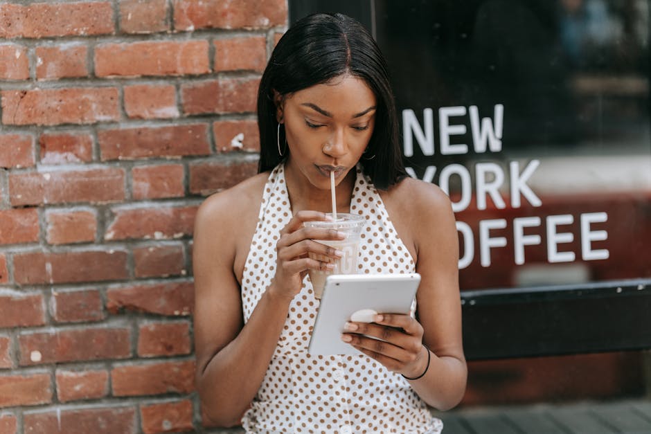 An inviting coffee shop environment with people enjoying their drinks while using their devices to book appointments.