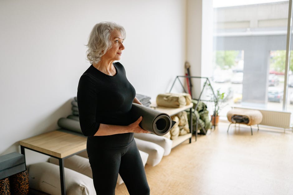 A bright and inviting yoga studio space filled with natural light, featuring yoga mats, plants, and a welcoming atmosphere that promotes tranquility.
