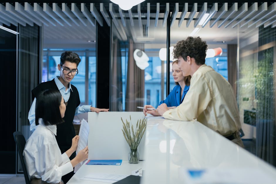 A modern office environment showcasing diverse employees interacting with AI technology, emphasizing collaboration and innovation.
