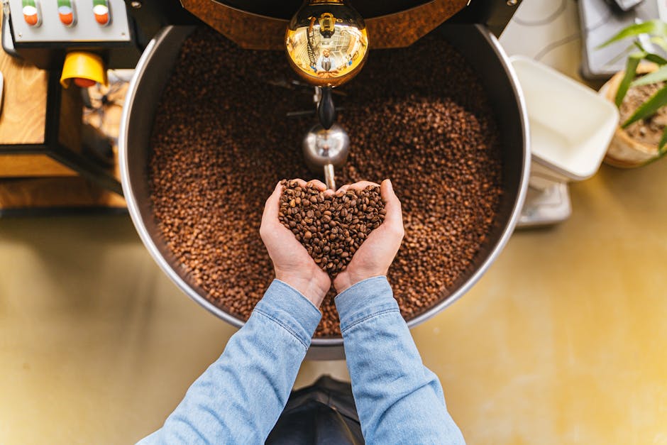 An artisan coffee roaster at work, surrounded by bags of green coffee beans, showcasing a warm, inviting atmosphere.