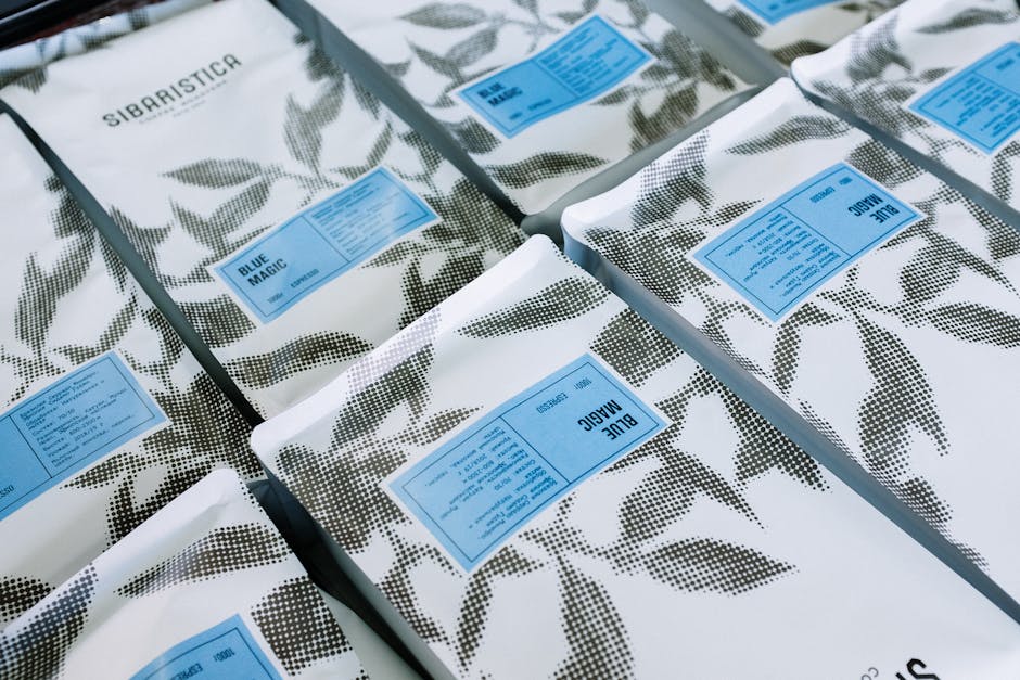 A visually appealing specialty coffee brand logo on biodegradable packaging surrounded by coffee beans.