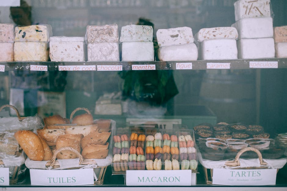 A colorful bakery counter with fresh pastries, alongside a phone displaying an incoming call with a friendly voicemail message bubble.