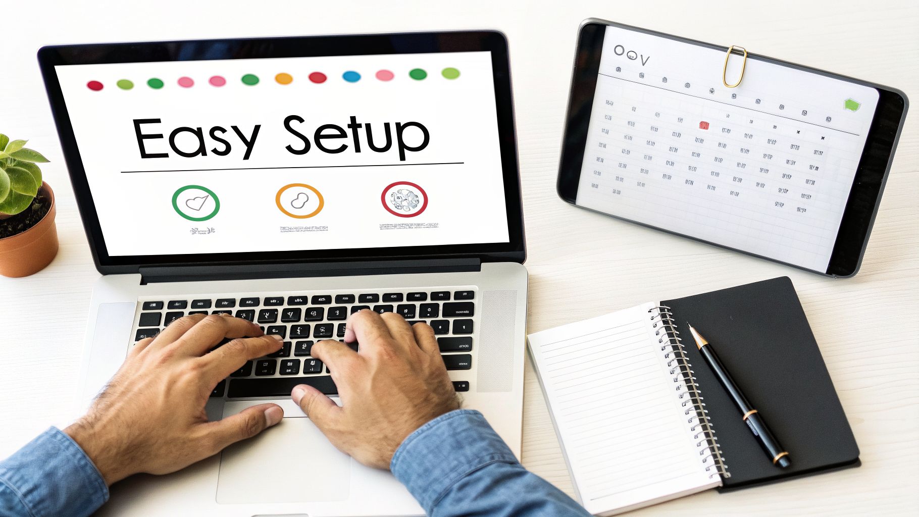 Person typing on a laptop with 'Easy Setup' on screen, a calendar, and notebook on a desk.