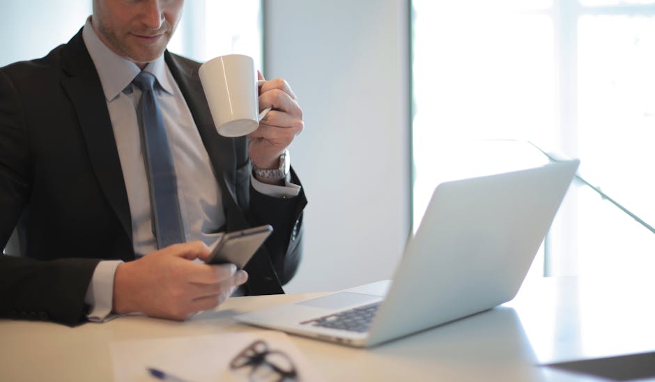 An office environment showcasing a professional using a smartphone with AI integration displayed on the screen.
