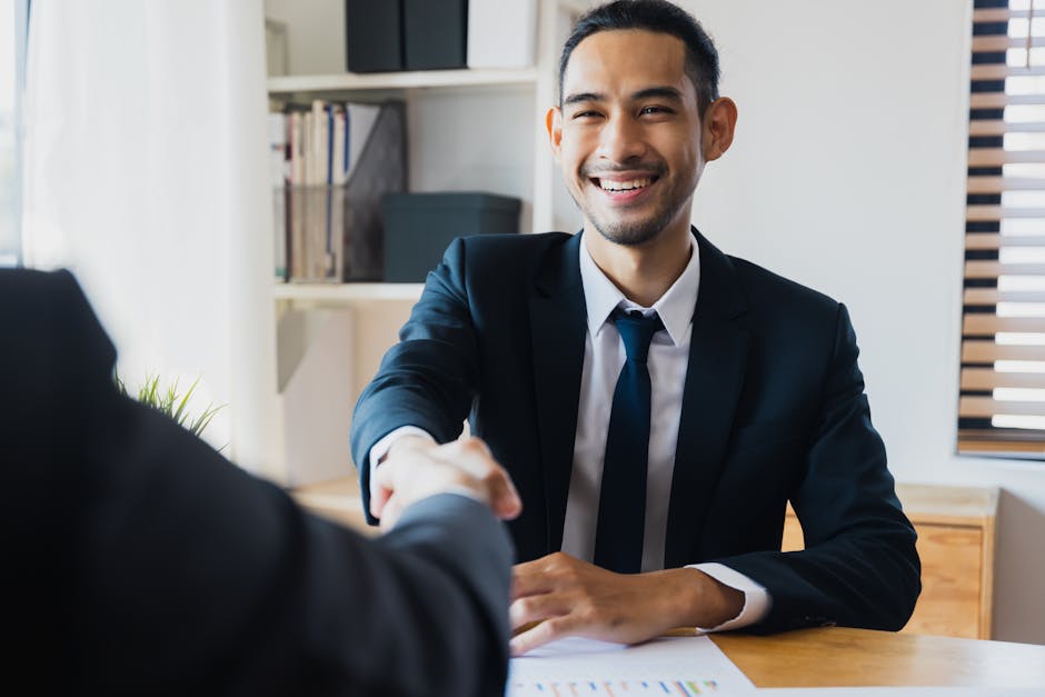A confident and approachable receptionist answering the phone with a smile, surrounded by positive customer interactions.