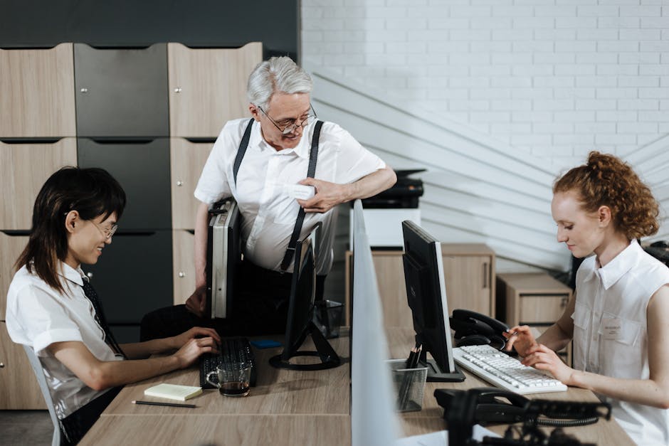 A bustling small business office with employees engaging on calls using VoIP technology, showcasing collaboration and productivity.
