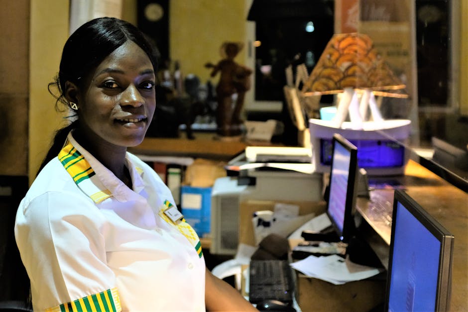 A bright and inviting urgent care reception area with a smiling staff member attending to a patient, illustrating good customer service and a welcoming environment.