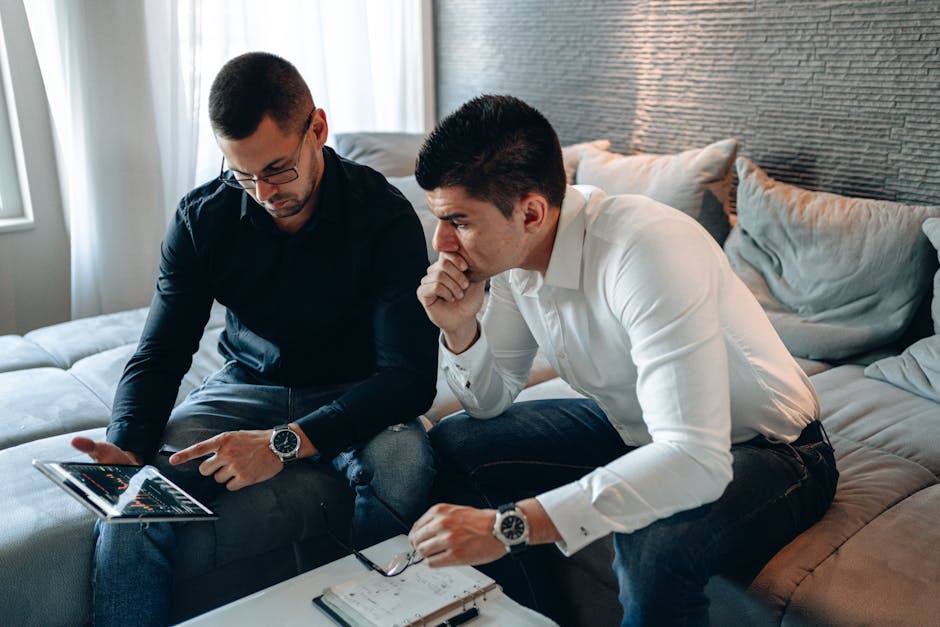 An entrepreneur discussing business growth strategies with a mobile device in hand, showcasing an innovative workspace filled with AI tools and a customer interaction screen.