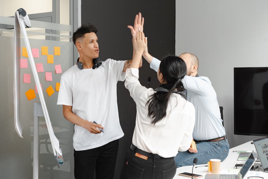 A dynamic office scene showing a diverse team engaging in calls with technology that illustrates connectivity and communication.