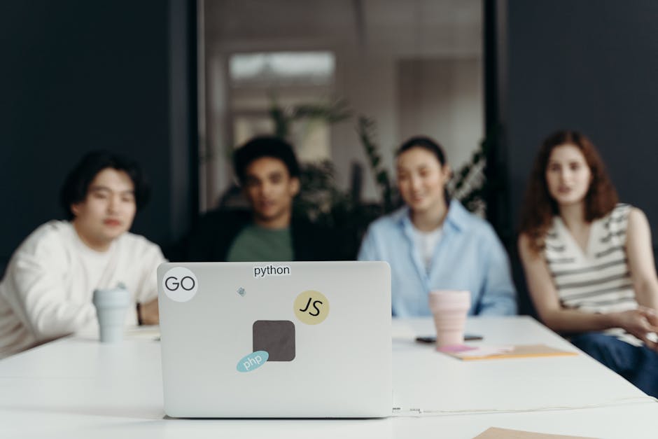 An image of a diverse group of professionals engaged in a virtual meeting, with VoIP software displayed on their screens.