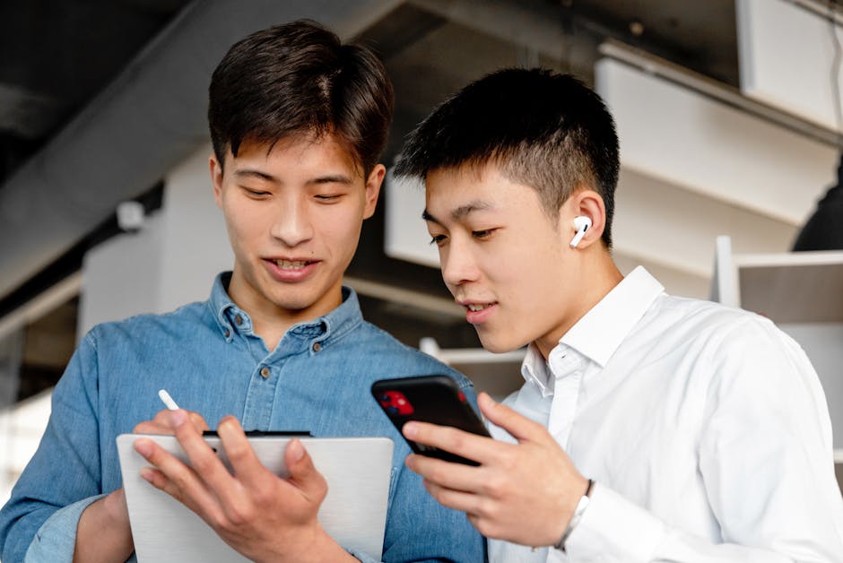A dynamic office scene showing team members collaborating seamlessly with mobile devices, illustrating the modern communication shift.