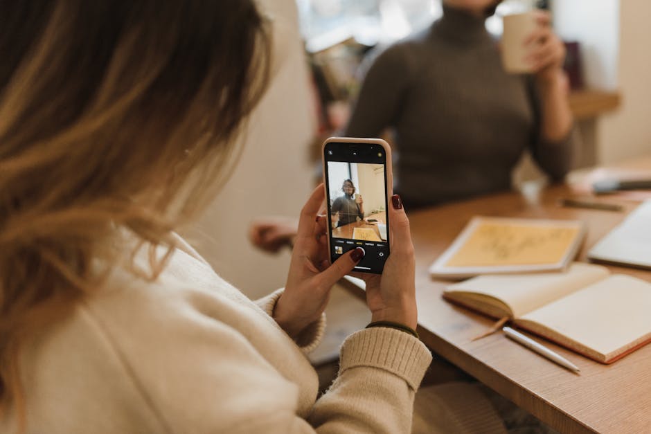 A creative visual of a team collaborating over shared digital voicemails on mobile devices in a modern workspace setting.