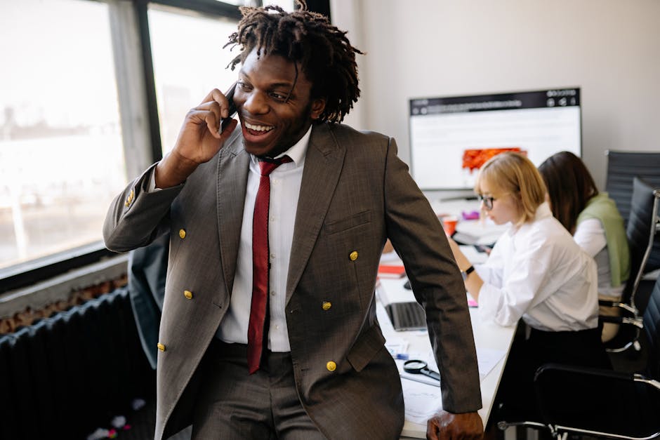A bustling office environment with employees engaging in productive discussions over phones, symbolizing seamless business communication