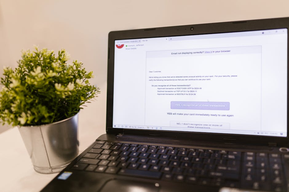 An elegant workspace with a laptop displaying an email communication interface and a missed call notification.
