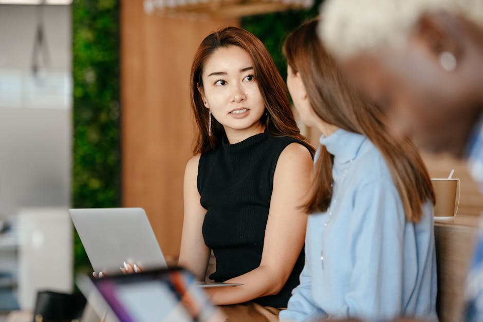 A vibrant office scene showcasing a diverse team utilizing AI tools to engage in a seamless conversation.
