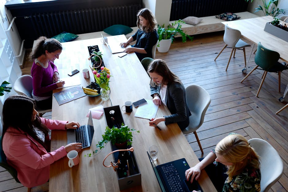A futuristic office environment where employees interact with AI receptionist technology, showcasing efficiency and innovation in communication.