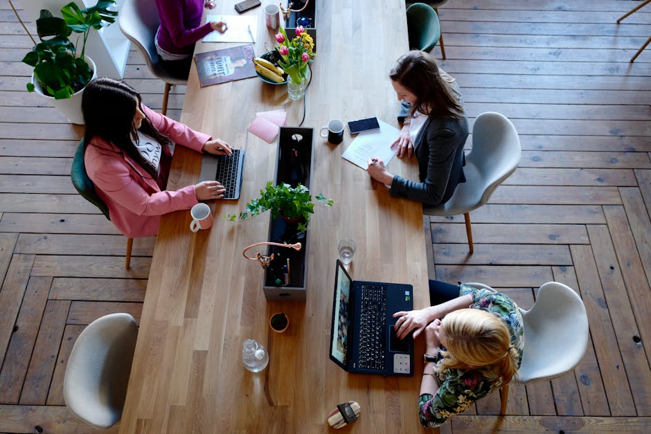A modern office scene with a professional working on a laptop, showcasing efficient communication methods.