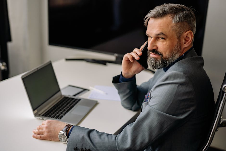 An image depicting a professional using a smartphone to manage voicemails effectively in a modern office setting.