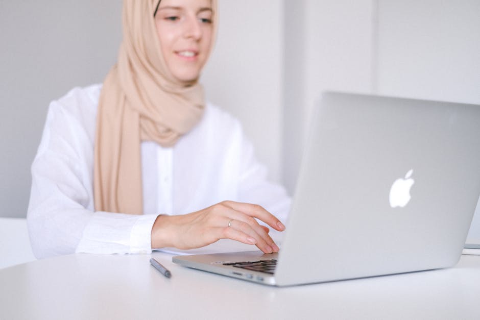 A modern office setting with a professional using an iPhone to manage voicemails, showcasing the seamless integration of technology in business communication.