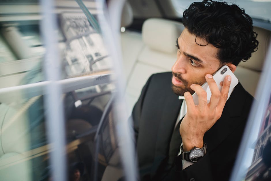 A business professional consulting a smartphone app to adjust call forwarding settings
