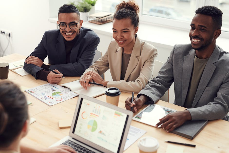 A team of professionals discussing mobile strategies in a modern office setting.