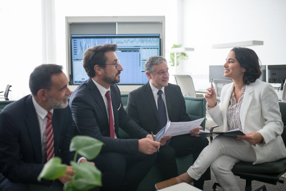 A vibrant office scene showcasing employees engaged in effective communication, highlighting teamwork and technology.