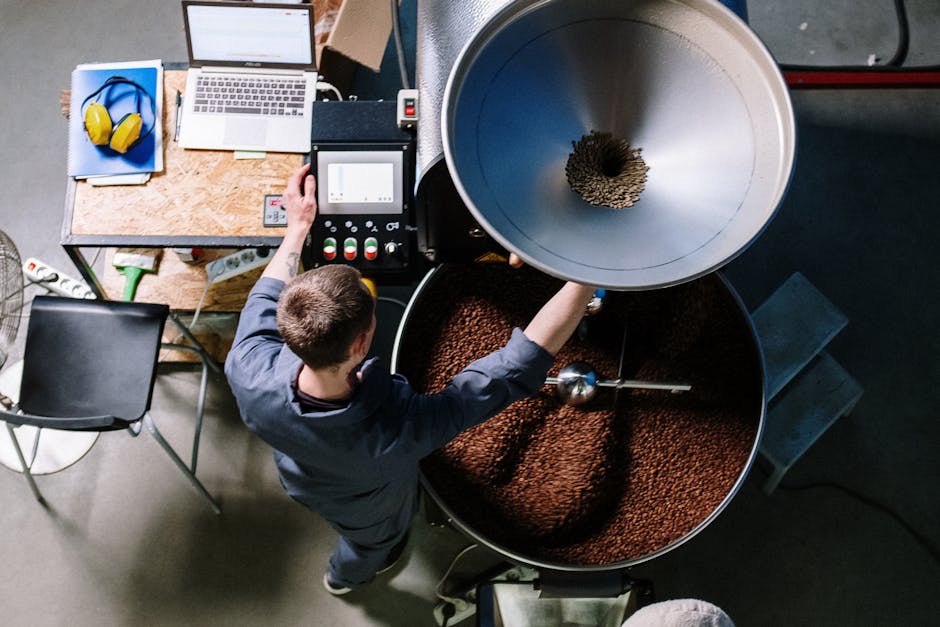 A bustling coffee roastery scene, highlighting employees working with coffee beans and roasting equipment.