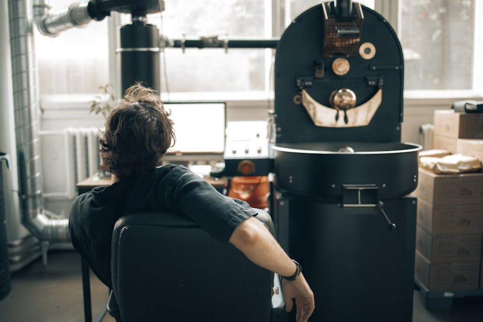 A coffee roasting machine operating in a bright, modern cafe setting, showcasing the roasting process.