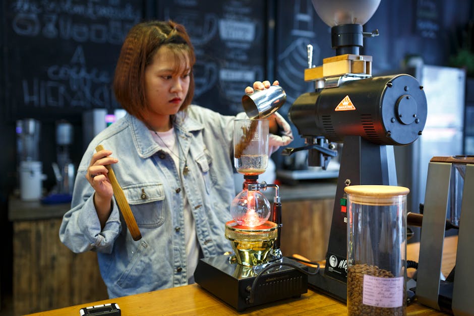 A skilled barista expertly roasting coffee beans, with equipment surrounding them, showcasing the artisanal side of coffee roasting.