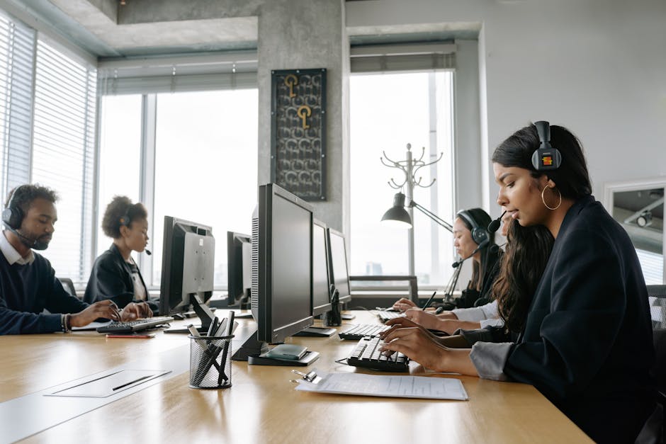 A vibrant, modern office environment with diverse team members using various devices for customer communication, emphasizing the integration of technology and personal interaction.