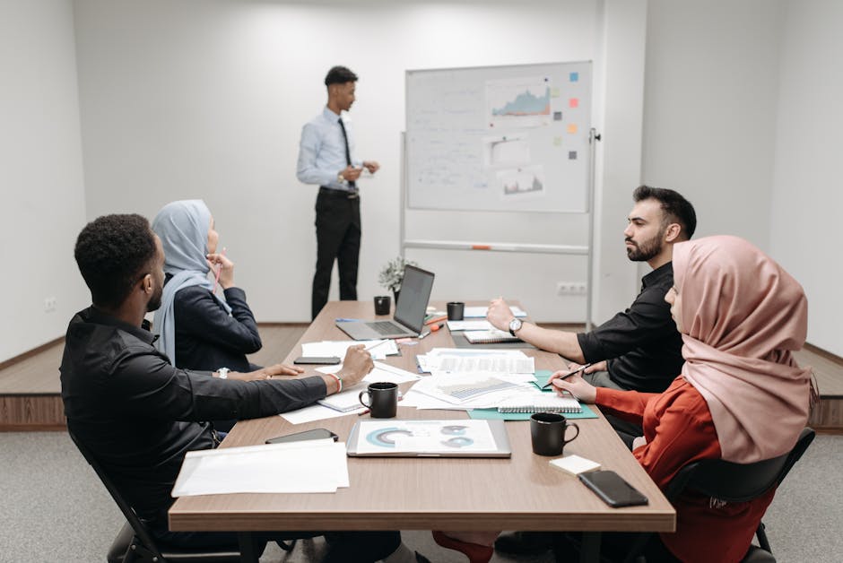 A modern office setting with diverse employees engaged in a video conference, showcasing global communication and AI technology.