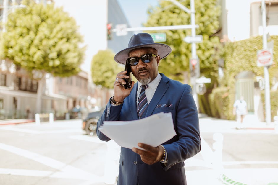 A customer on a phone call reviewing insurance documents, focused and prepared.