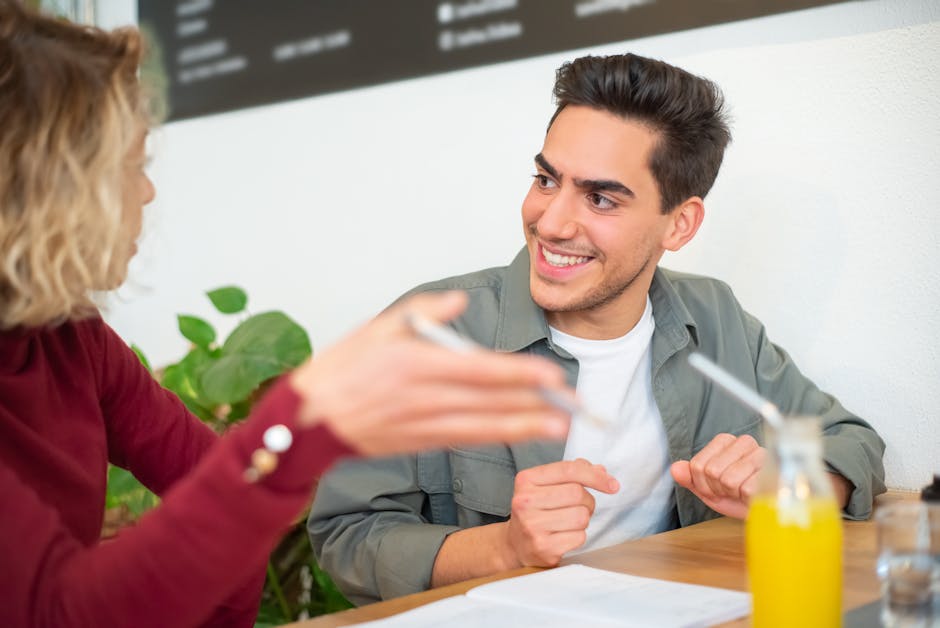 A vibrant image of a business person smiling while speaking on a phone with a notepad in front, symbolizing positive communication.