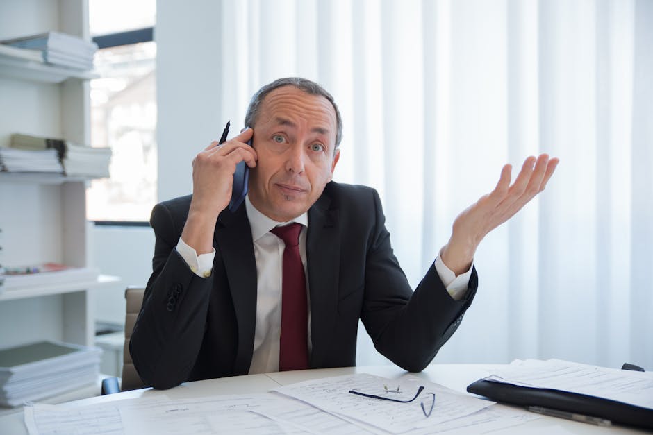 A vibrant office scene illustrating a business professional leaving a voicemail, smartphone in hand, with a thoughtful expression.