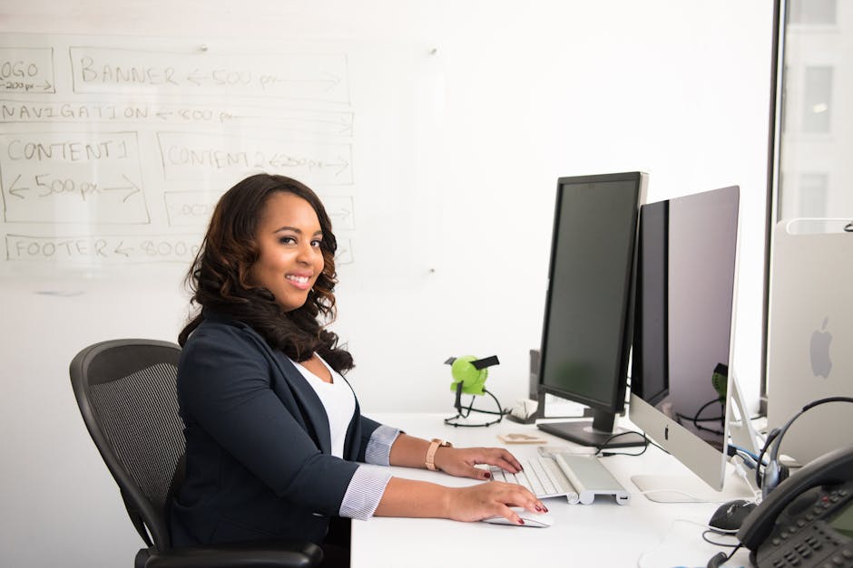 An entrepreneur smiling at a computer with a clear representation of a modern AI receptionist interface, showing engagement with clients.