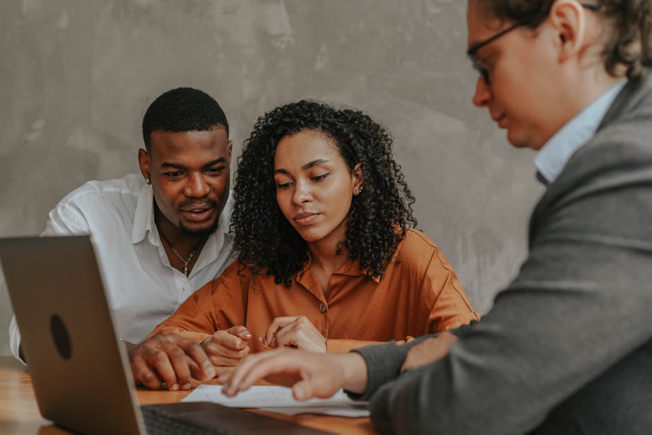 A vibrant office scene with employees engaged in collaborative discussions, emphasizing communication and focus.