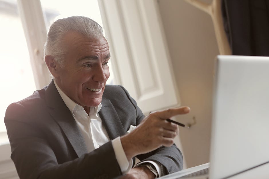 Image of a professional in an office setting managing calls on multiple devices, depicting a modern communication environment.